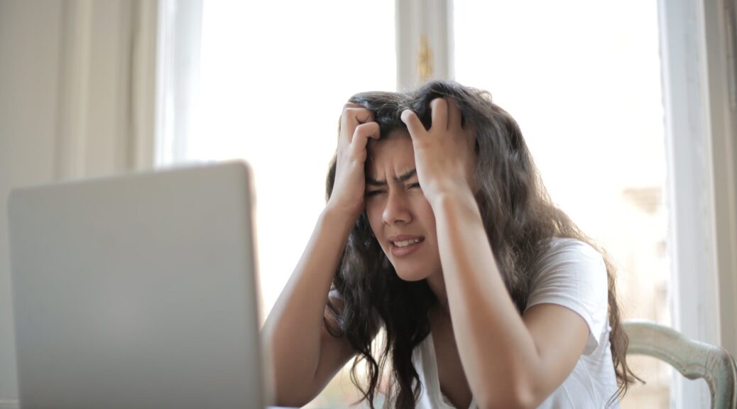 woman in white shirt showing frustration